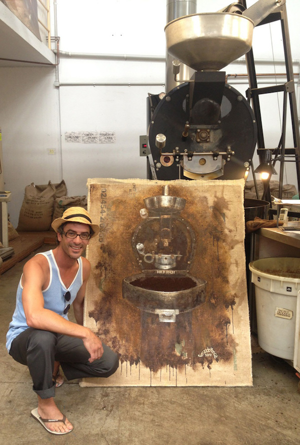 Fernando Mosca and a Diedrich roaster painted with spent coffee grounds. Photo courtesy of Sacred Grounds Organic and Fairtrade. 