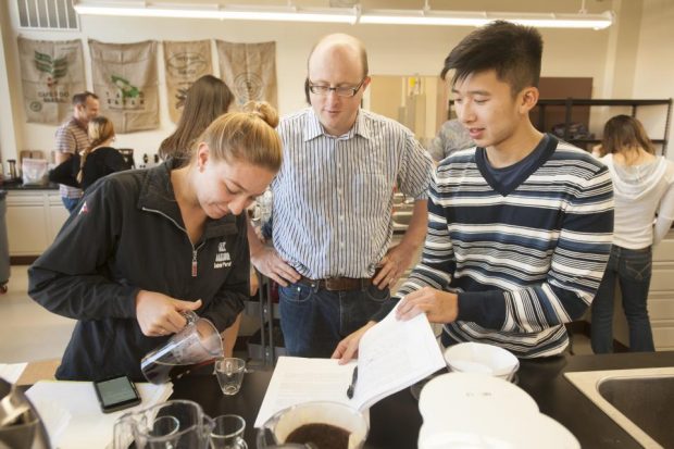 Associate professor William Ristenpart talks with Sabrina Perell, community regional development major, and Kyle Phan, an undeclared major, about the taste of their brew during a UC Davis “Design of Coffee” class in 2015. UC Davis photo by Gregory Urquiaga. 