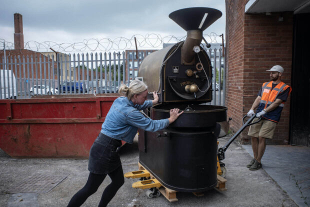 Lisa Lawson pushes the roaster into the new roastery[63]